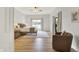 Bright main bedroom featuring wood floors, a ceiling fan, and a sliding glass door that provides backyard access at 6640 Page Blvd # 101, Indianapolis, IN 46220