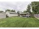 A spacious backyard with a shed and a charming covered area with a bench offers an excellent spot for relaxation at 6649 Madison Ave, Indianapolis, IN 46227