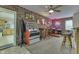 Finished basement with a bar area, barstools, and neon beer signs at 6649 Madison Ave, Indianapolis, IN 46227