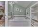 Relaxing bathroom features a soaking tub, shower head, and shelving at 6649 Madison Ave, Indianapolis, IN 46227