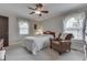 Cozy bedroom with a ceiling fan, two windows, and classic decor at 6649 Madison Ave, Indianapolis, IN 46227