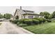 Charming stone home with lush, manicured landscaping and a well-maintained lawn at 6649 Madison Ave, Indianapolis, IN 46227