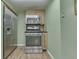 Galley kitchen features stainless steel appliances, hardwood floors, and ample cabinet space at 6649 Madison Ave, Indianapolis, IN 46227