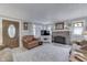 Cozy living room with a brick fireplace, wood-look floors, and a comfy leather armchair at 6649 Madison Ave, Indianapolis, IN 46227