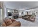 Inviting living room with a brick fireplace, comfortable seating, and abundant natural light from windows at 6649 Madison Ave, Indianapolis, IN 46227