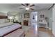 Large main bedroom with hardwood floors, exposed brick, and a sitting area at 6649 Madison Ave, Indianapolis, IN 46227