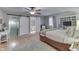 Sun-filled main bedroom boasts hardwood floors, ample lighting, and ensuite bath access at 6649 Madison Ave, Indianapolis, IN 46227