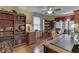 Classic home office with hardwood floors, bookshelves, a leather chair and plenty of workspace at 6649 Madison Ave, Indianapolis, IN 46227