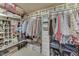 Spacious walk-in closet with extensive storage, including shelving, hanging rods, and labeled storage boxes at 6649 Madison Ave, Indianapolis, IN 46227