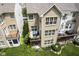 An aerial view features a brick home with a private balcony, overlooking a beautifully landscaped backyard with lush greenery at 692 Greenford N Trl, Carmel, IN 46032