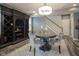 Elegant dining room featuring a unique lighting fixture, gray walls, and wine storage at 692 Greenford N Trl, Carmel, IN 46032
