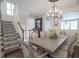 Dining room with chandelier, hardwood floors, and easy access to kitchen and stairs at 692 Greenford N Trl, Carmel, IN 46032