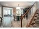 Elegant dining room with gray walls, unique lighting fixture and seating, and staircase at 692 Greenford N Trl, Carmel, IN 46032