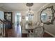 Dining room with hardwood floors, view to kitchen, and access to stairwell at 692 Greenford N Trl, Carmel, IN 46032