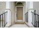 Close-up of the front door showcasing the covered entrance, white columns, and black railings at 692 Greenford N Trl, Carmel, IN 46032