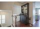 Open hallway with wood floors, white railings, and a decorative cabinet, naturally lit at 692 Greenford N Trl, Carmel, IN 46032
