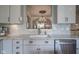 Kitchen with stainless appliances, undermount sink, and designer backsplash and cabinets at 692 Greenford N Trl, Carmel, IN 46032