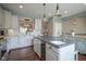 Bright kitchen with island, wine fridge, white cabinetry, and stainless appliances at 692 Greenford N Trl, Carmel, IN 46032