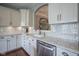 Modern kitchen with stainless appliances, white cabinets, marble counters, and backsplash at 692 Greenford N Trl, Carmel, IN 46032