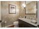 Elegant powder room with decorative wallpaper, a marble countertop, and a framed picture for a stylish touch at 692 Greenford N Trl, Carmel, IN 46032