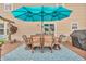 Outdoor patio with dining set under a large umbrella, ideal for al fresco meals and gatherings at 7047 Lancaster Ln, Avon, IN 46123
