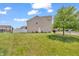Spacious backyard with lush lawn and mature tree, perfect for outdoor activities and relaxation at 7047 Lancaster Ln, Avon, IN 46123