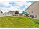 Landscaped backyard with a patio, hot tub, grilling station, and privacy fence, perfect for outdoor living at 7047 Lancaster Ln, Avon, IN 46123