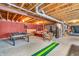 Basement featuring concrete floor, concrete walls, exposed ceiling with a game area and decorations at 7047 Lancaster Ln, Avon, IN 46123