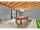 Spacious unfinished basement featuring exposed ceiling beams and a vintage-style pool table at 7047 Lancaster Ln, Avon, IN 46123