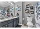 Stylish bathroom featuring a double vanity, granite countertop, decor, and a shower with a decorative curtain at 7047 Lancaster Ln, Avon, IN 46123