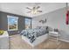 This bedroom features a ceiling fan, two windows, and a view of the neighborhood at 7047 Lancaster Ln, Avon, IN 46123