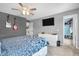 Well-lit bedroom with ceiling fan, dresser, TV, and access to the walk-in closet at 7047 Lancaster Ln, Avon, IN 46123