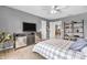 Well-lit bedroom with bed, TV, closet, shelving unit, and a view into the next room at 7047 Lancaster Ln, Avon, IN 46123
