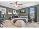 Stylish bedroom with modern decor, including artwork, shelving, and a ceiling fan at 7047 Lancaster Ln, Avon, IN 46123