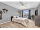 Cozy bedroom with neutral tones, carpet, TV, ceiling fan and natural light from the window at 7047 Lancaster Ln, Avon, IN 46123