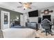 Well-lit bedroom featuring neutral walls, a ceiling fan, and a dedicated gaming setup with multiple monitors at 7047 Lancaster Ln, Avon, IN 46123