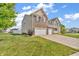 Charming two-story home with brick and siding exterior, well-manicured lawn, and a two-car garage at 7047 Lancaster Ln, Avon, IN 46123
