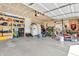 Functional garage featuring storage shelving, various equipment and tools and bikes at 7047 Lancaster Ln, Avon, IN 46123