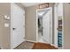 Hallway that has hardwood floors, showing doors to the laundry room with neutral walls and trim at 7047 Lancaster Ln, Avon, IN 46123