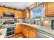 Well-lit kitchen featuring wood cabinetry, granite countertops, and stainless steel appliances at 7047 Lancaster Ln, Avon, IN 46123