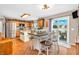 Bright kitchen with wood flooring, island with seating, and stainless steel appliances at 7047 Lancaster Ln, Avon, IN 46123