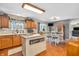 Bright kitchen with an island, hardwood floors, eat-in dining area, and sliding glass doors to the backyard at 7047 Lancaster Ln, Avon, IN 46123