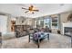 Spacious living room with a fireplace, plush seating, and natural light from large windows at 7047 Lancaster Ln, Avon, IN 46123