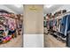 This walk-in closet offers ample storage with clothing racks and shelving on both sides at 7047 Lancaster Ln, Avon, IN 46123