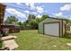 Spacious backyard featuring a detached garage, patio, and lawn at 710 S Bancroft St, Indianapolis, IN 46203