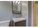 Bathroom vanity with a modern faucet, mirror and tiled backsplash at 710 S Bancroft St, Indianapolis, IN 46203