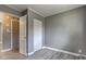This is a bedroom with gray walls, vinyl flooring, and closet space at 710 S Bancroft St, Indianapolis, IN 46203