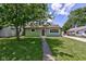 Charming single-story home with green exterior, well-maintained lawn, and inviting walkway at 710 S Bancroft St, Indianapolis, IN 46203