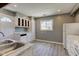 Bright kitchen showcases white cabinetry, essential appliances, and laminate flooring for a clean, modern feel at 710 S Bancroft St, Indianapolis, IN 46203