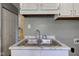 A well-maintained stainless steel kitchen sink and laminate countertop with ample storage space at 710 S Bancroft St, Indianapolis, IN 46203